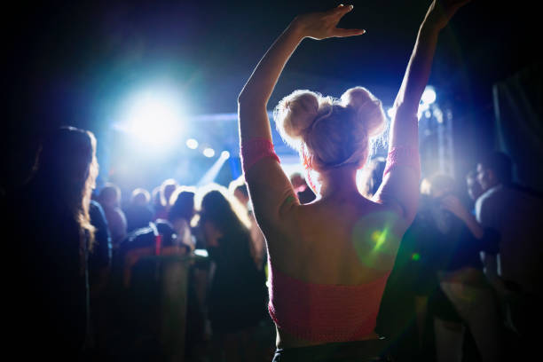 Rear view of a girl dancing at the nightclub.